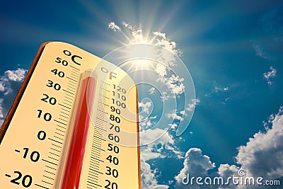 Thermometer on blue sky with sun shining in summer show higher Weather Stock Photo