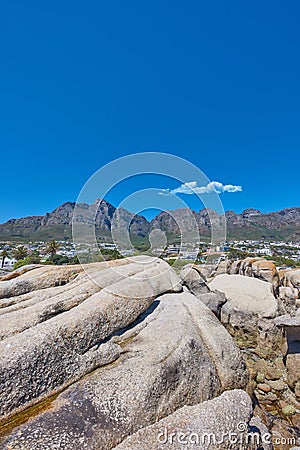 Low angle view of the Twelve Apostles mountain range in South Africa against a blue sky. Closeup of rocky landscape Stock Photo