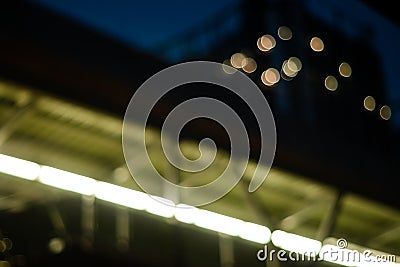 Low angle view of walkway overpass and condominium in the night.light yellow.blur bokeh background. Stock Photo