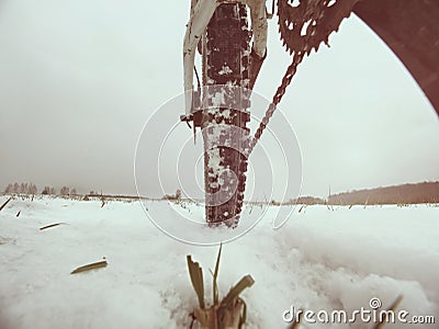 Low ankle photo of rear hweel of mtb in snowdrift. Picture taken within winter bike trip Stock Photo