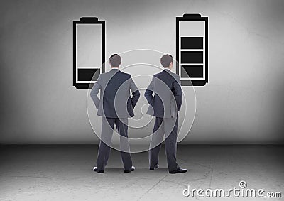 Low battery and charged battery with Businessman looking in opposite directions Stock Photo