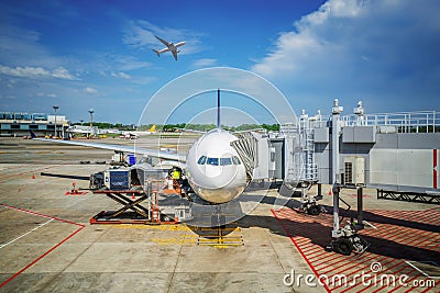 Low cost airline and small airplane loading Editorial Stock Photo