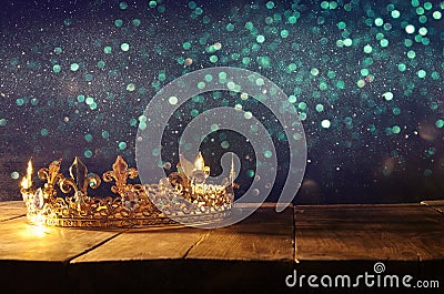 low key of beautiful queen/king crown over wooden table. vintage filtered. fantasy medieval period Stock Photo