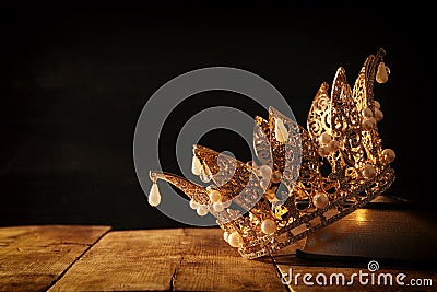 low key image of beautiful queen/king crown on old book. fantasy medieval period. Selective focus. Stock Photo