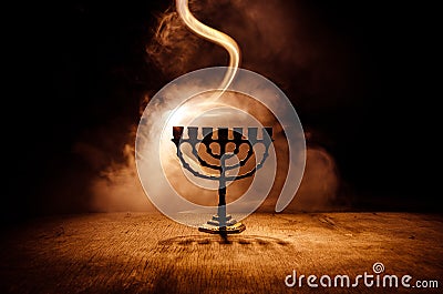 Low key image of jewish holiday Hanukkah background with menorah on dark toned foggy background Stock Photo