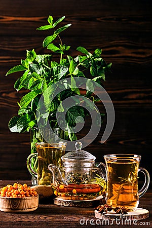 Low key photo of hot herbal tea with sea buckthorn and mint Stock Photo