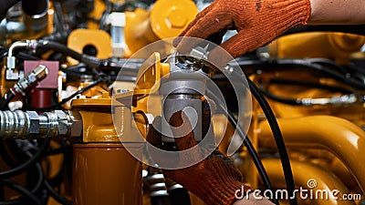 Low key photo of hydraulic pipes maintenance on heavy industry machine Stock Photo