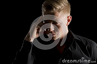 Low key portrait of attractive man looking aside. Stock Photo