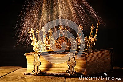 low key of queen/king crown on old book. vintage filtered. fantasy medieval period Stock Photo
