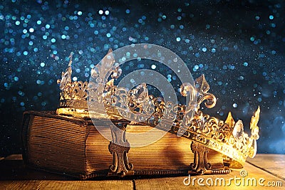 low key of queen/king crown on old book. vintage filtered. fantasy medieval period Stock Photo