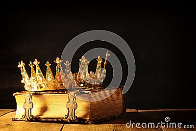 low key of queen/king crown on old book. vintage filtered. fantasy medieval period Stock Photo