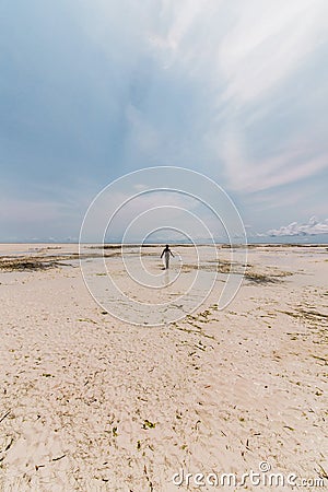 Low ocean tide and one human silhouette stands on the shore Stock Photo