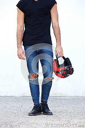 Low portrait of motorcyclist holding helmet Stock Photo