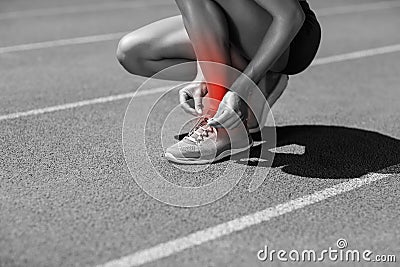 Low section of athlete tying shoelace on sports track Stock Photo