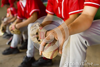 Low Section Of Baseball Team Mates Sitting In Dugout Stock Photo