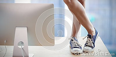 Composite image of low section of businesswoman standing on table by computer Stock Photo
