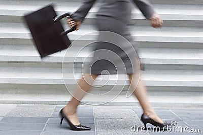 Low Section OF Businesswoman Walking Stock Photo