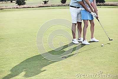 Low section of couple playing golf Editorial Stock Photo