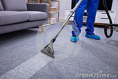 Male Janitor Cleaning Carpet Stock Photo