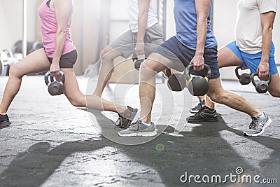 Low section of people lifting kettlebells at crossfit gym Stock Photo