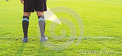 Low section of Soccer assistant referee (Linesman) standing on the edge of field, panoramic view with copy space Stock Photo