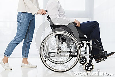 low section woman pushing man sitting wheelchair. High quality beautiful photo concept Stock Photo