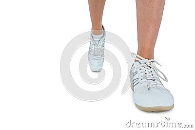 Low section of woman wearing sports shoe running Stock Photo