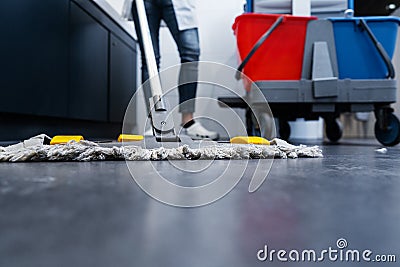 Low shot of cleaning lady mopping the floor in restroom Stock Photo