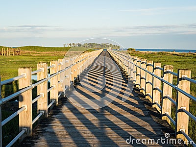 Boardwalk, perspective with vanishing point leading lines and shadow pattern Stock Photo