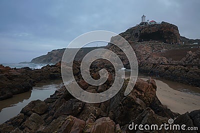 Low tide, textured volcanic rock and the shore Stock Photo