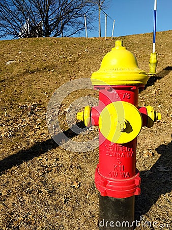 LOWELL MA / USA - JANUARY 09, 2020: Red and yellow fire hydrant manufactured by Kennedy Valves headquartered in Elmira, NY Editorial Stock Photo