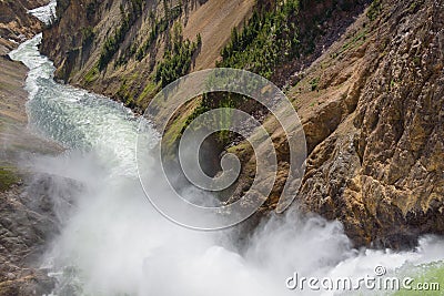Lower falls Yellowstone river. Raging waters. Spray from waterfall. Stock Photo