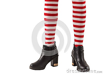 Lower half of girl wearing stripey socks and boots Stock Photo