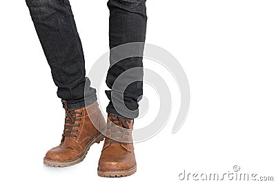 Lower half of Man leg and foot wearing jeans and shoes on isolated white background. Fashion and people concept. Parts of body Stock Photo