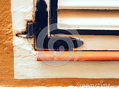 Lower left section of a shutter on a house wal Stock Photo