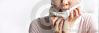 Lower part part of woman face with Red bubbles of virus herpes on her lips she tries to hide it under white knitted neckwarmer, Stock Photo