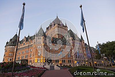 Lower point of view of renowned Chateau Frontenac with UNESCO sculpture and flags Editorial Stock Photo