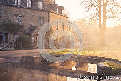 Lower Slaughter in the Cotswolds on the River Windrush in the mist Stock Photo