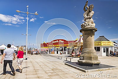 Lowestoft Promeade with Triton Statue, South Pier and Couple Holding Hands Editorial Stock Photo