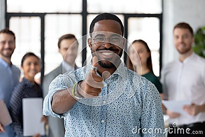 Loyal black male client demonstrating thumb up recommending good service Stock Photo