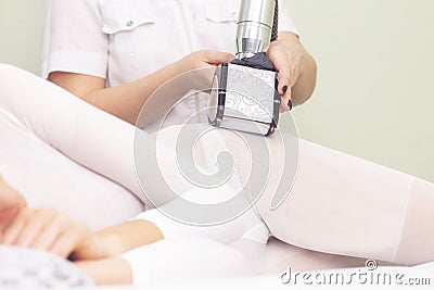 lpg girl body massage in spa. The girl is given a hardware massage, she is wearing a special jumpsuit for massage. cavitation, cel Stock Photo