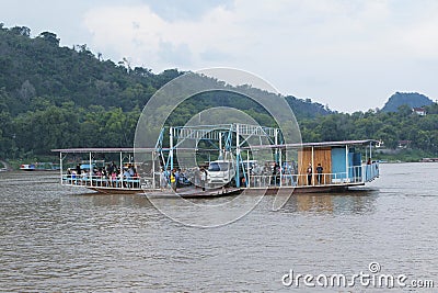 luangprabang lao-july18,2023 : land vehicle and people on car ferry crossing mekong river at xiangman port luangprabang district Editorial Stock Photo