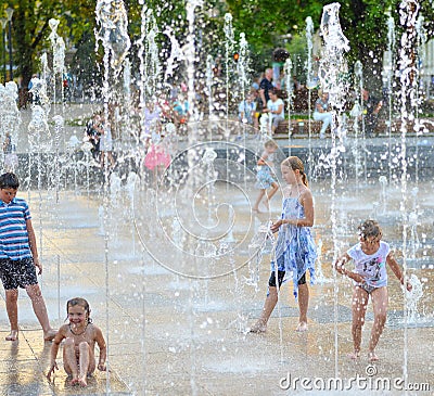 Children playing in beautiful modern fountain in park, Lublin Editorial Stock Photo