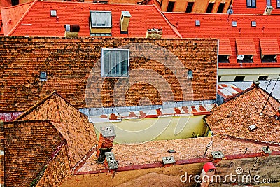 Old houses with tiled grosses harmoniously merge with the roofs of the houses of new buildings. Editorial Stock Photo