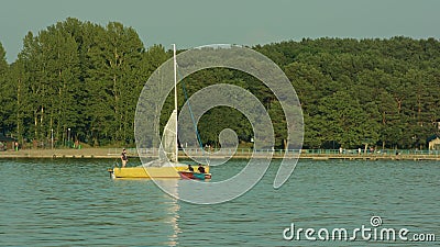 Young Men Taking Down a Sail on the Yacht Editorial Stock Photo