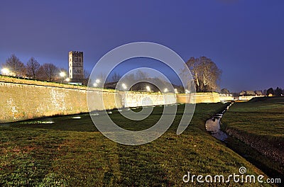 The walls of Lucca by night and the moat in front of it Stock Photo