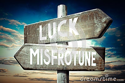 Luck, misfortune - wooden signpost, roadsign with two arrows Stock Photo