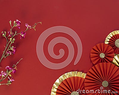 Lucky Chinese new year red background decoration with cherry blossom flower and paper fan Stock Photo