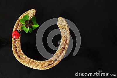 Lucky horseshoe with shamrock and ladybug Stock Photo