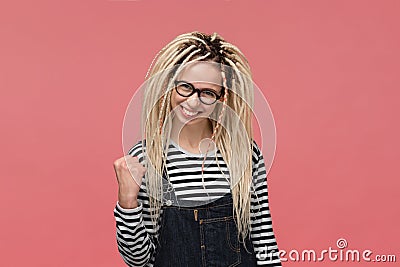 Lucky young girl with long dreads showing gesture of success Stock Photo